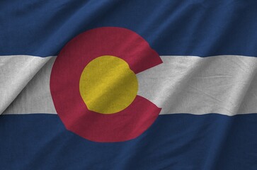 Colorado US state flag depicted on folded wavy fabric of old cloth close up