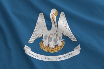 Louisiana US state flag depicted on folded wavy fabric of old cloth close up