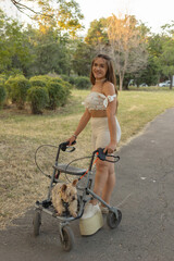 Disabled walking in rollator at park.