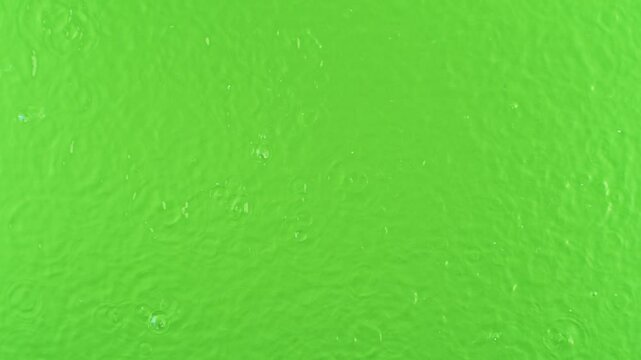 Super Slow Motion of Water Drops Falling Down in Extreme Detail. Isolated on Green Screen Background. Filmed on High Speed Cinema Camera, 1000fps.