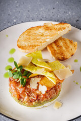 delicious fresh salmon tartar on a white plate