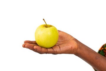 close up of a female hand holding an apple.