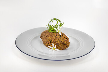 Minced fish dumplings, perfectly decorated on a white plate on white background