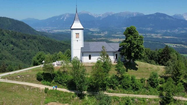 Aerial morning view of St. Primoz church at Jamnik, Slovenia, Julian alps.