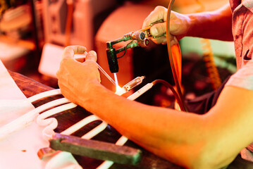 Close-up of a Craftsman Working With a Torch on a Neon Light Glass Tube