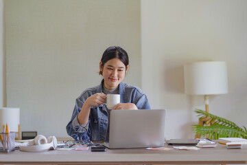 Woman using laptop at workplace start work in morning