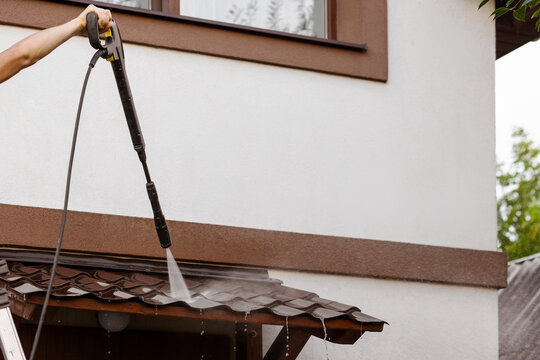 Cleaning Roof with Pressure Washer of Residential House. Karcher Pressure Washing for Cleaning Service Business. 