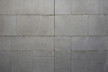 Naklejka premium Close-up of smooth grey concrete brick wall background