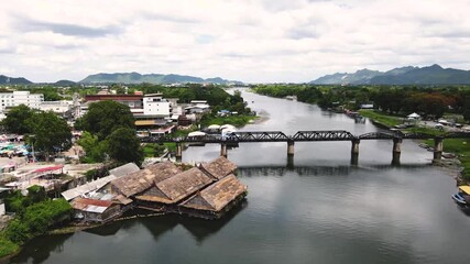 The Bridge River Kwai, Kanchanaburi, Thailand. The Death Railway, World War II, by the Japanese Army, which conscripted approximately 61,700 Allied prisoners of war. Opened 1943. Drone view. Video.
