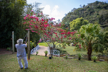 elderly man with white hair exercising outdoors in a green field