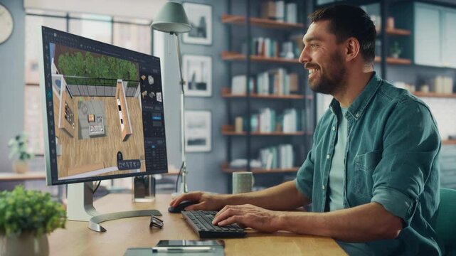 Male Interior Designer Working Behind a Desk in Office, Using Computer Software to Choose, Move and Manipulate 3D Furniture in a Cozy Home Project. Professional Working on a Comfortable Flat
