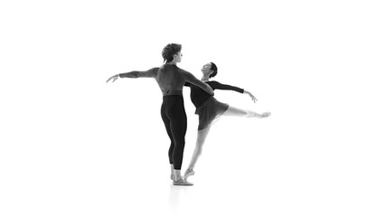 Ballet partners training their movements in practice against white studio background. Black and white filter. Concept of pair training, classic ballet, inspiration, beauty, creativity. Ad.