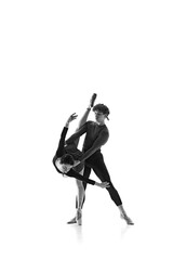 Ballet duo, graceful man and woman, perfecting dynamic bend against white studio background. Monochrome filter. Concept of pair training, classic ballet, inspiration, beauty, creativity. Ad.