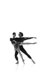 Ballet duo, man and woman perfecting their graceful dance moves in motion against white studio background. Sepia filter. Concept of pair training, classic ballet, inspiration, beauty, creativity. Ad.