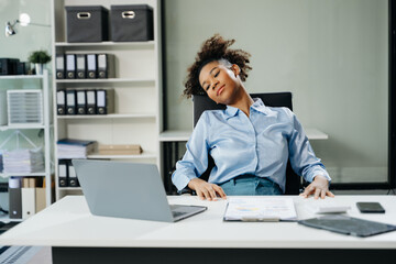 Overworked young businesswoman office worker suffering from neck pain after had a long day. office syndrome concept