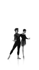 Graceful ballet pair, artistic man and woman dedicated to refining their dance moves against white studio background. Sepia filter. Concept of pair training, classic ballet, inspiration, beauty. Ad.