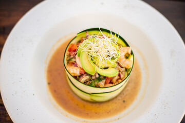 mexican ceviche of fish and shellfish marinated in citrus and seasonings deliciously served wrapped in cucumber thin slices