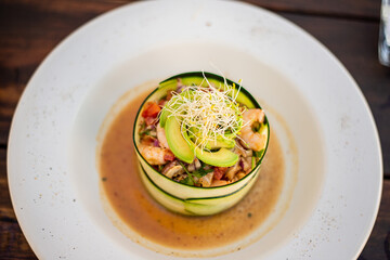 mexican ceviche of fish and shellfish marinated in citrus and seasonings deliciously served wrapped in cucumber thin slices