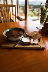 Ukrainian borscht with croutons and sour cream on the table. Ukrainian cuisine concept. Borscht with meat