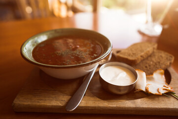 Ukrainian borscht with croutons and sour cream on the table. Ukrainian cuisine concept. Borscht with meat