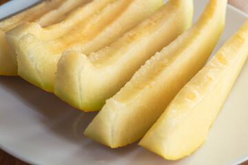 Sliced ​​melon on a plate close-up. Melon slices on a plate