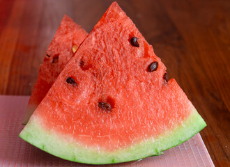 Watermelon cut into triangles. A triangular piece of watermelon
