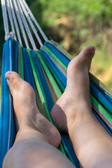 "Legs in a Hammock: Outdoor Activities and Summer Relaxation"