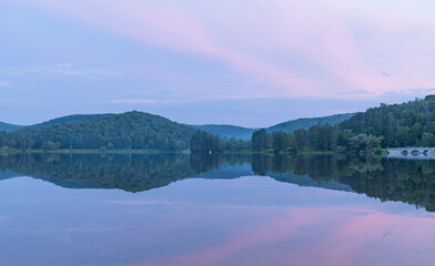 Setting sun low light long exposure over mountain lake summer season background image