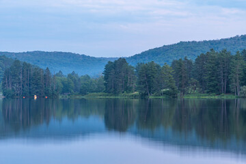 Setting sun low light long exposure over mountain lake summer season background image
