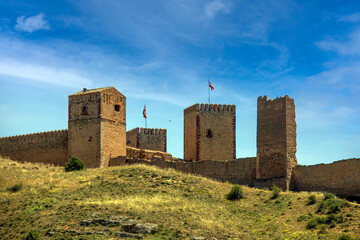 View of the Molina de Aragon castle, Guadalajara, Castilla-La Mancha, Spain, with its imposing towers and wall in midday light