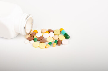 Pharmaceutical preparations Colorful medications Pills  tablets and capsules are poured from the jar. Medical concep