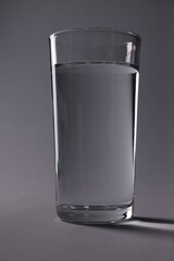 Glass of fresh water on grey background