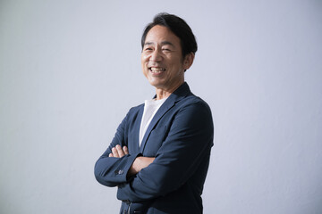 Smiling businessman with folded arms