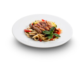 Plato de pasta con pato y verduras sobre fondo blanco. Pasta dish with duck and vegetables on white background.