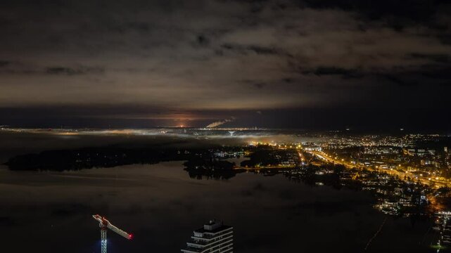 Timelapse of mist moving over the illuminated Kulosaari island, night in Helsinki