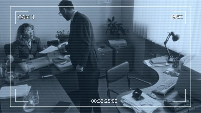CCTV high angle shot of male clerical worker bringing documents to female typewriter and taking sit at table with old computer, working together in retro office in 90s