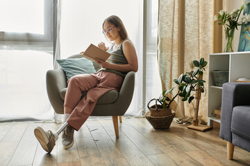 A young woman with a prosthetic leg relaxes in a comfortable chair, engrossed in a book. Natural...