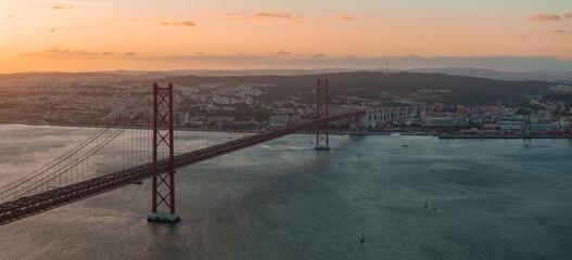 Aerial view of the 25th April Bridge .- Ponte 25 de Abril - is a suspension bridge road-rail over the Tagus river that connects the city of Lisbon to the city of Almada. Panoramic view from above.