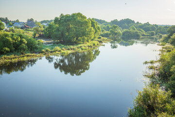 Fototapeta premium A calm river with trees on both sides
