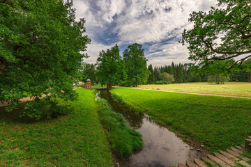 A peaceful scene of a river running through a lush green field