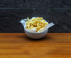 Shoestring Fries served in dish isolated on wooden table side view of italian fastfood