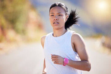 Fototapeta premium Girl, running and athlete in outdoor for fitness, or training, exercise and physical cardio for marathon. Female runner, wellness and practice for race on road, serious and endurance for workout.