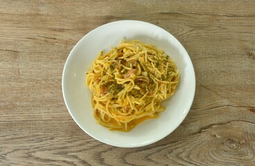 fried spaghetti slice ham pork with chop garlic in carbonara cheese cream sauce on plate   