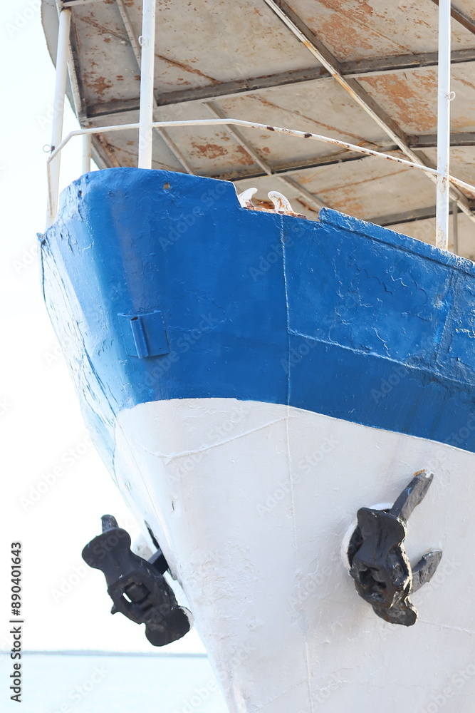 Poster a close-up of a boat moored at a dock, with details of the vessel and surrounding area visible.