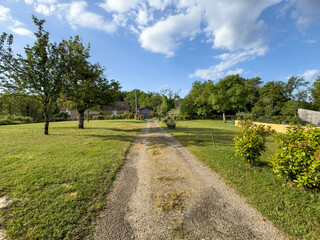 path or road in countryside leads to village