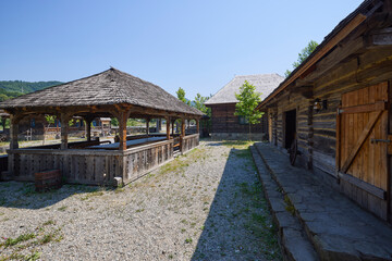 Fototapeta premium landscape with different traditional houses from Maramures, Romania, Houses built predominantly from wood.