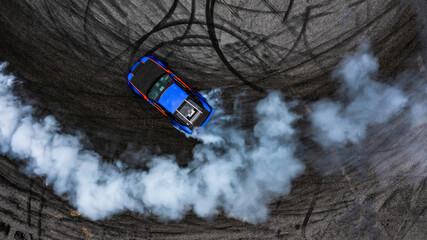 Aerial top view car drifting diffusion race drift car with lots of smoke from burning tires on speed track, Professional driver drifting car with lots of white smoke.