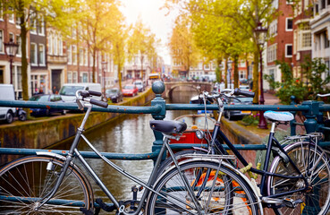 Amsterdam, Netherlands. Bikes on the bridge channel of Amsterdam city. Typical amsterdam transport, bicycles streets. Picturesque urban street vew in Netherland © Yasonya