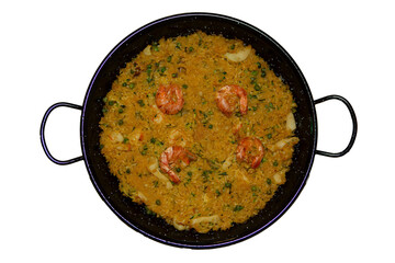 Iron dish with homemade Spanish paella, featuring traditional ingredients.