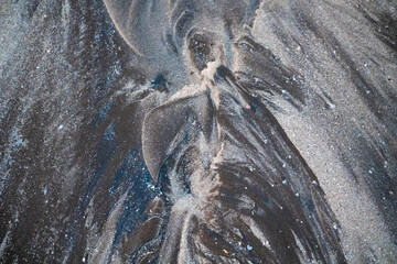 Natural texture: top view of beach sand, clear, clean and smooth. Minimalist background for summer concepts, travel, vacations and outdoor enjoyment.